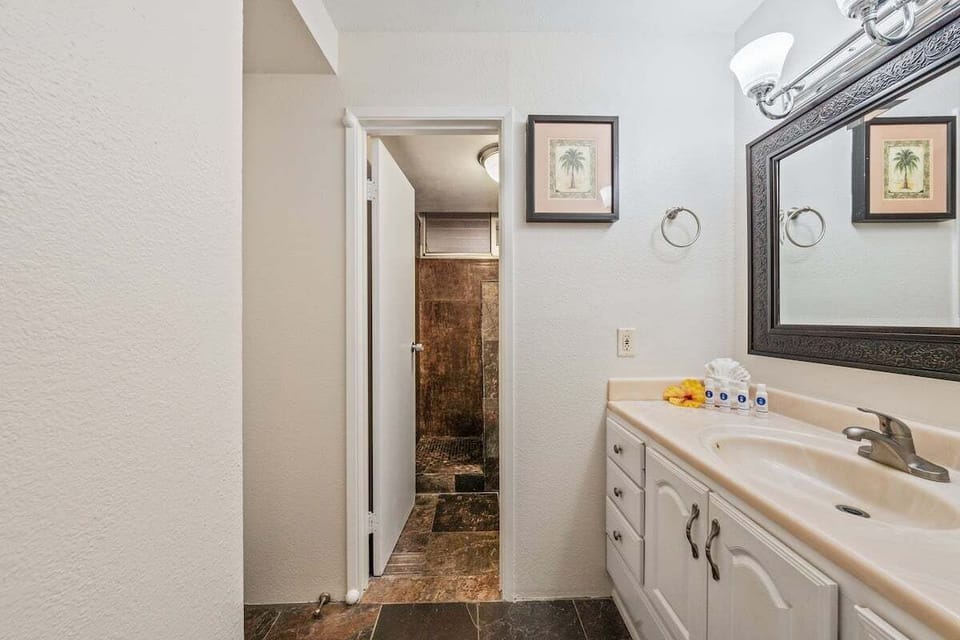 Step into a wider view, towels and décor adding warmth to the stone‑tiled shower beyond.