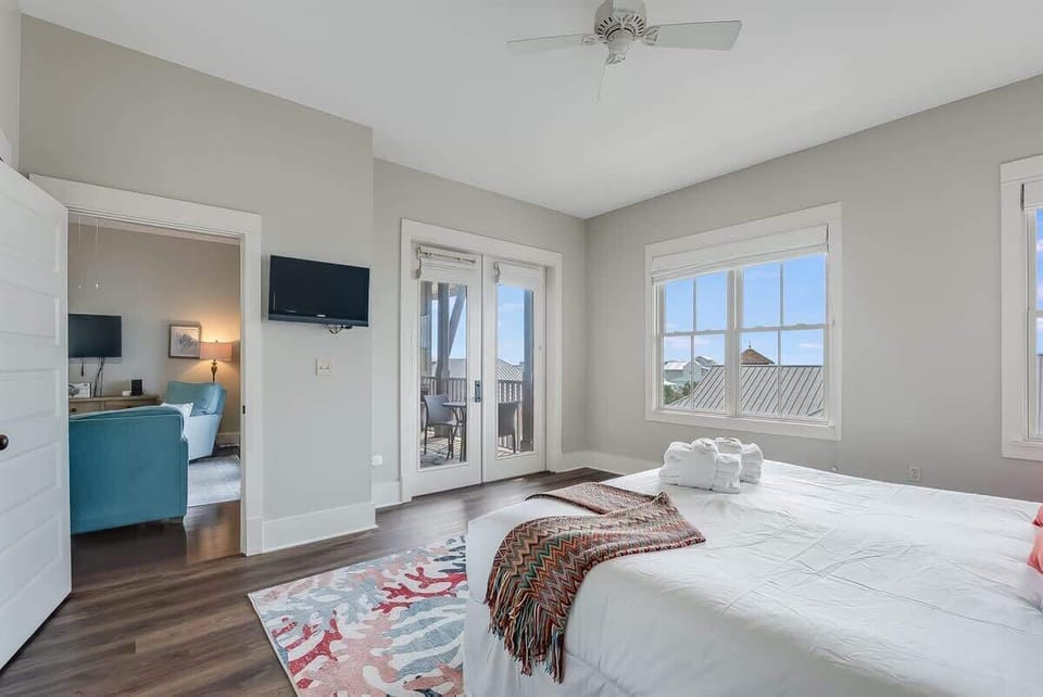 - Wake up to peaceful views from the large windows & private balcony just outside your room • Soft linens, pastel decor, & ceiling fan offer breezy comfort after a beach day • Direct access to living area & outdoor seating creates a connected retreat