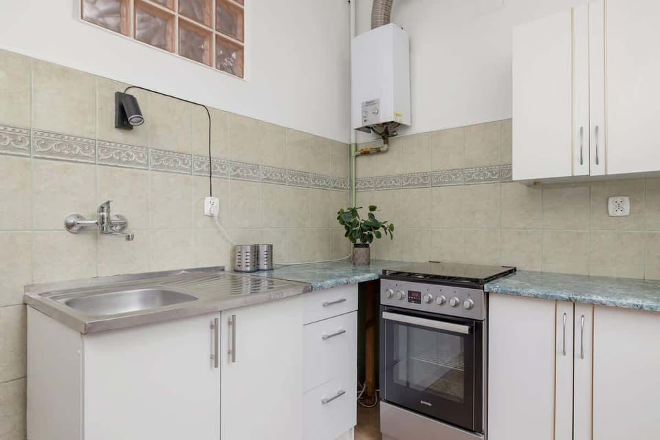 A functional kitchen with an oven and spacious countertop is perfect for preparing home-cooked meals.