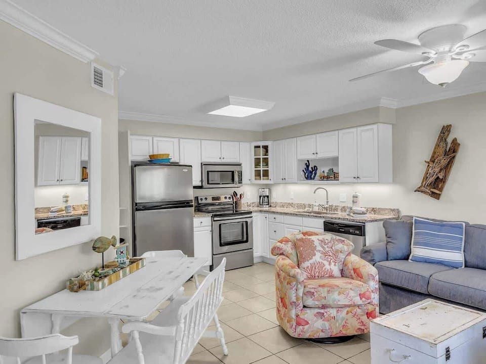 Open concept kitchen and living with dining seating for 4