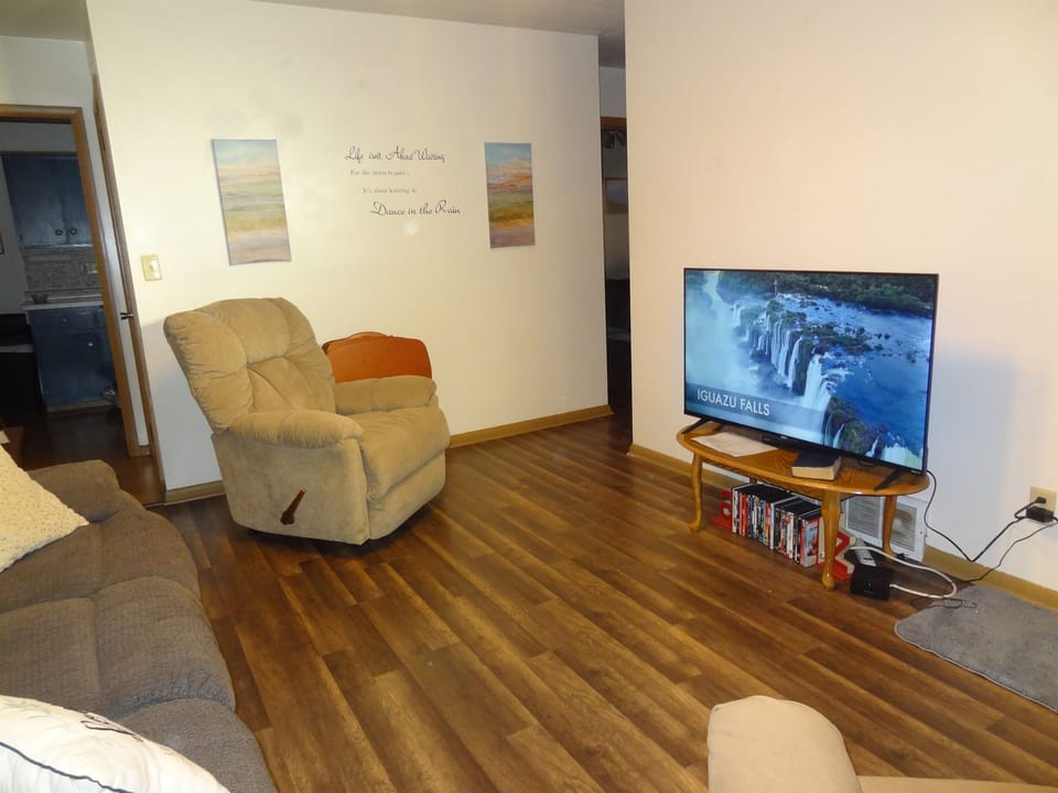 Living room with 2 recliners, reclining couch and Roku smart TV