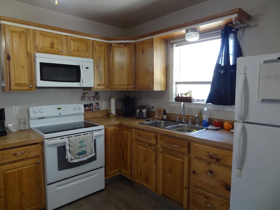 Kitchen with full stove and refrigerator