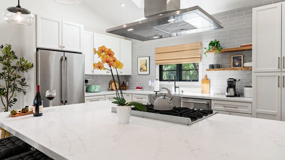 Cook in the beautiful kitchen with gas burners, large fridge, and plenty of counter space.