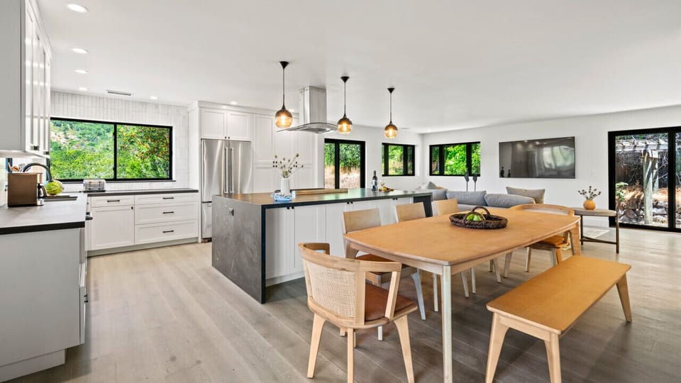This kitchen and dining room space offers guests an amazing dining experience with views of the mountainside.