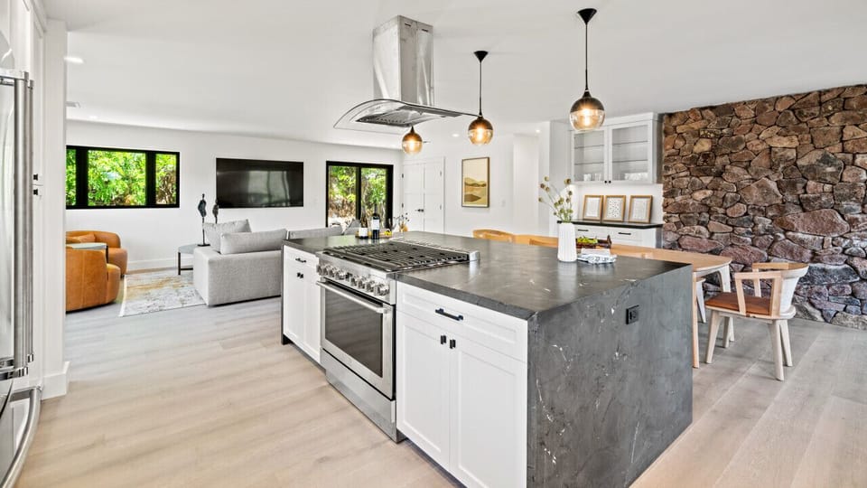Kitchen with gas stove and full fridge/freezer
