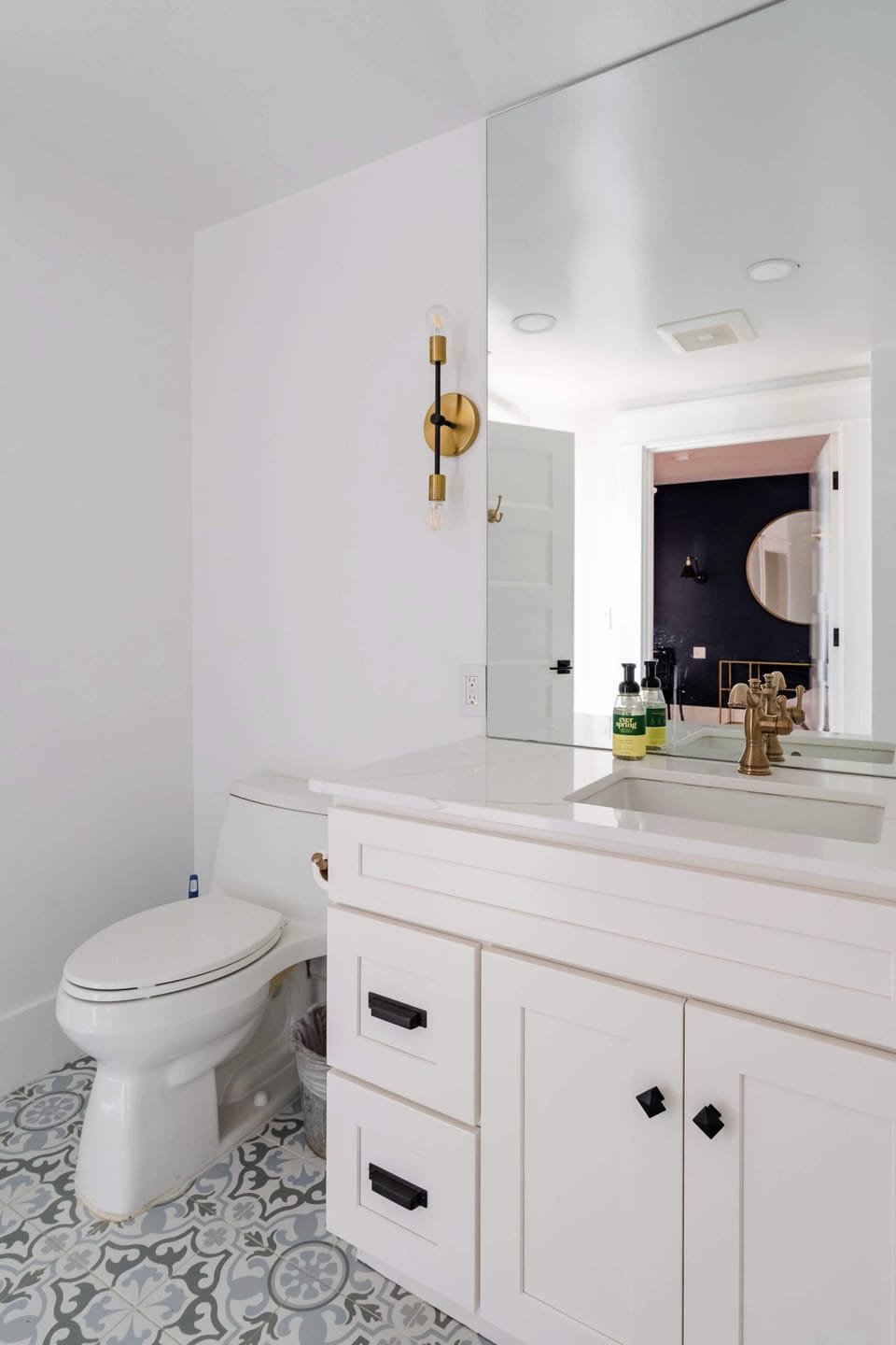 Bathroom with a white vanity and toilet.