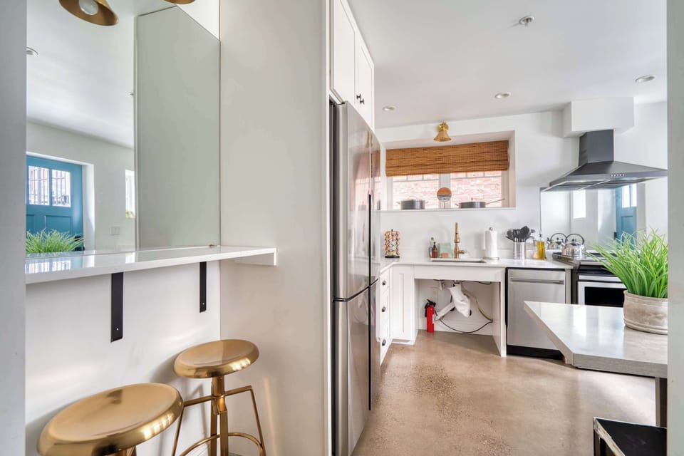 Kitchen with range and breakfast stools.