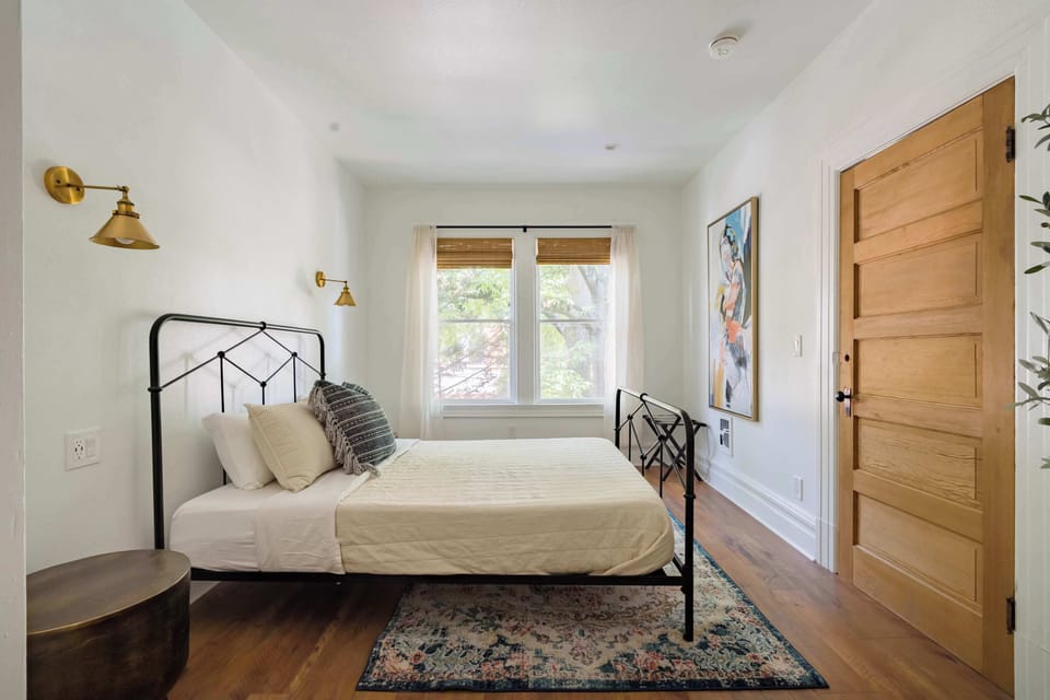 Bedroom 5 with queen bed and window light.