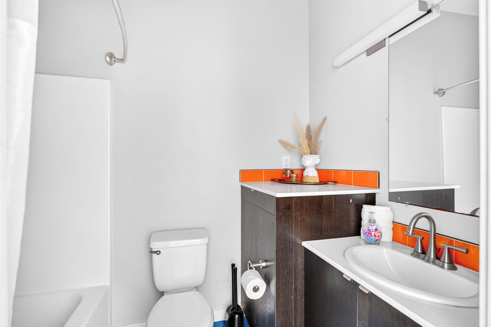 Bathroom with bathtub, shower, and vanity.