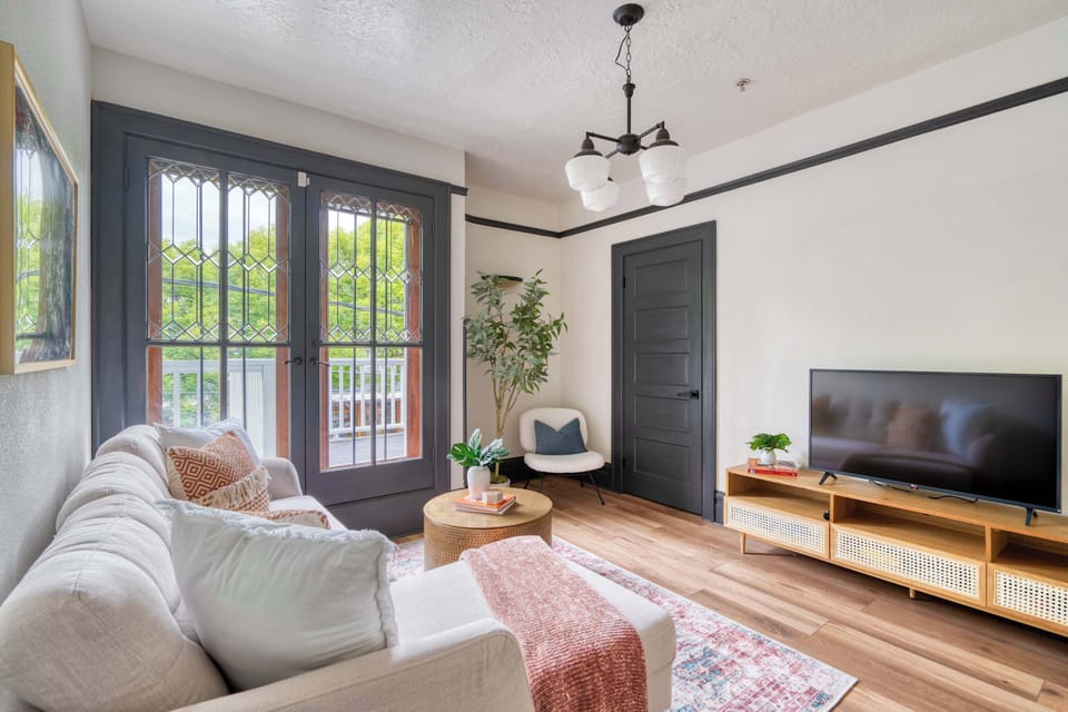 Living room with pale sofa and TV.