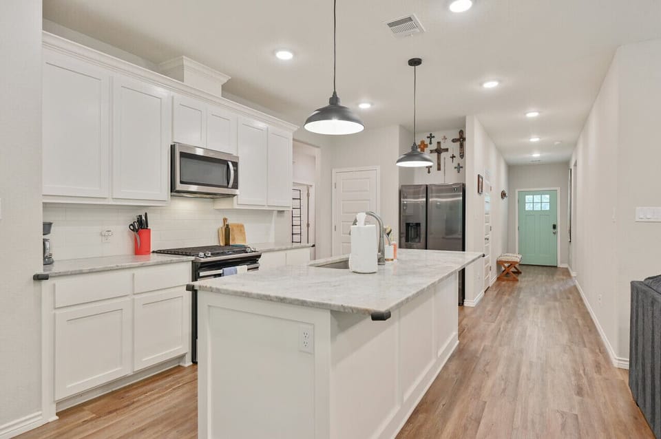 You are welcomed by a gorgeous, sleek, and open concept kitchen.