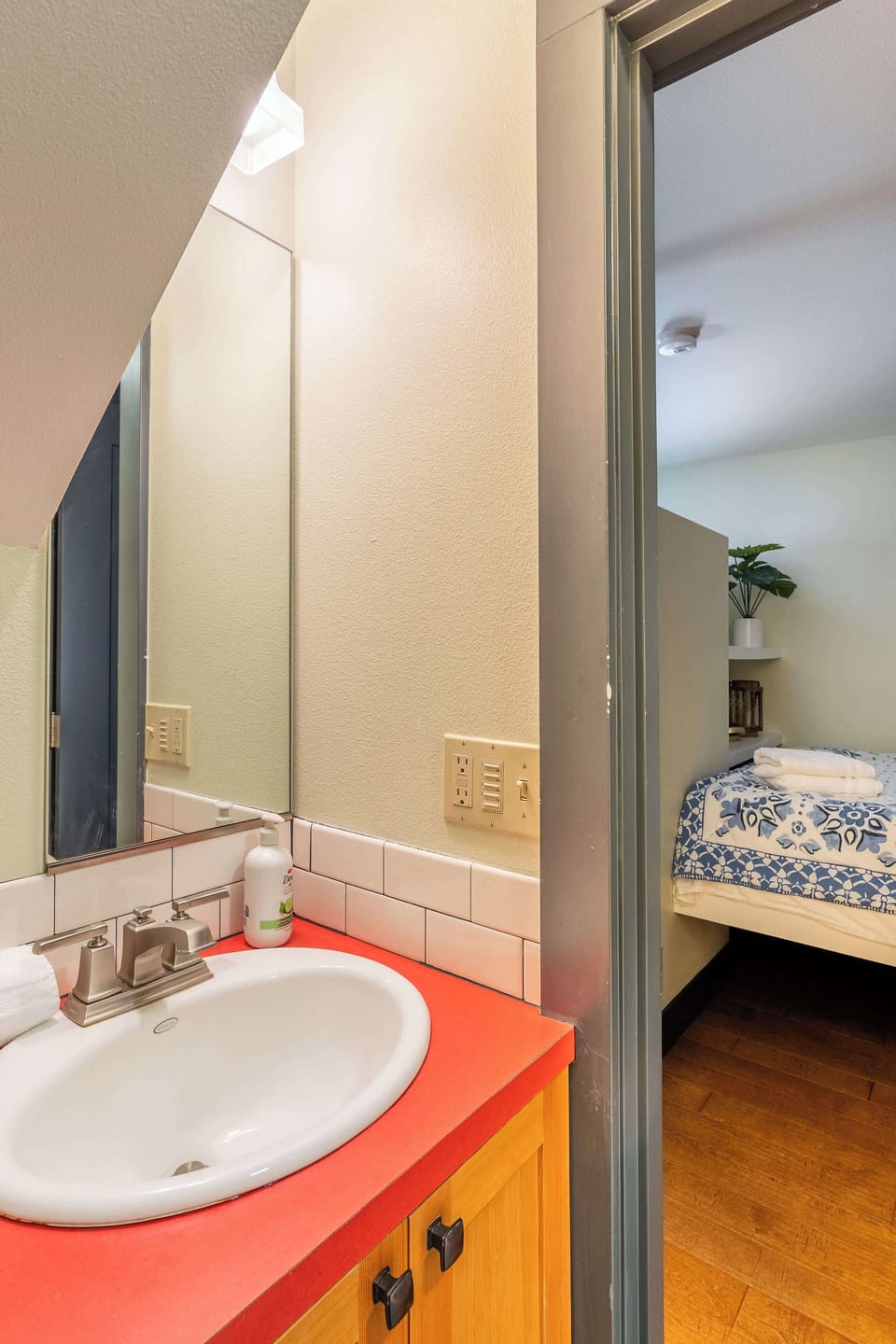 Bathroom vanity beside the sleeping-area doorway.