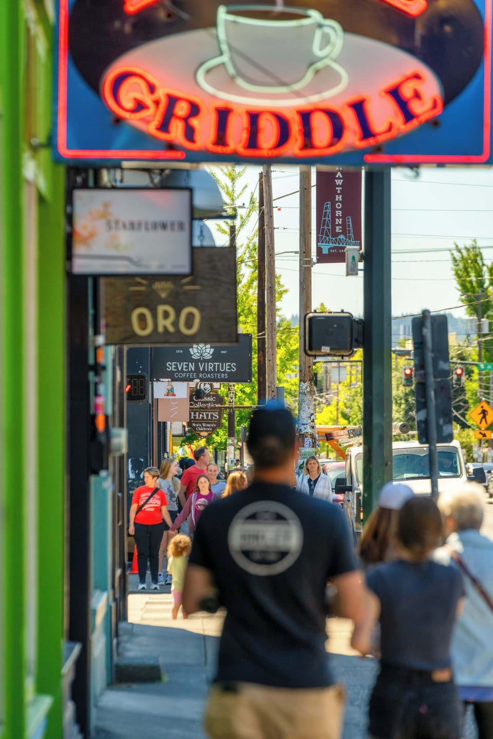 Neighborhood scene: Sidewalk scene beneath the Little Griddle sign.