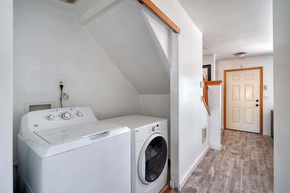 Washer and dryer beneath the stairway.