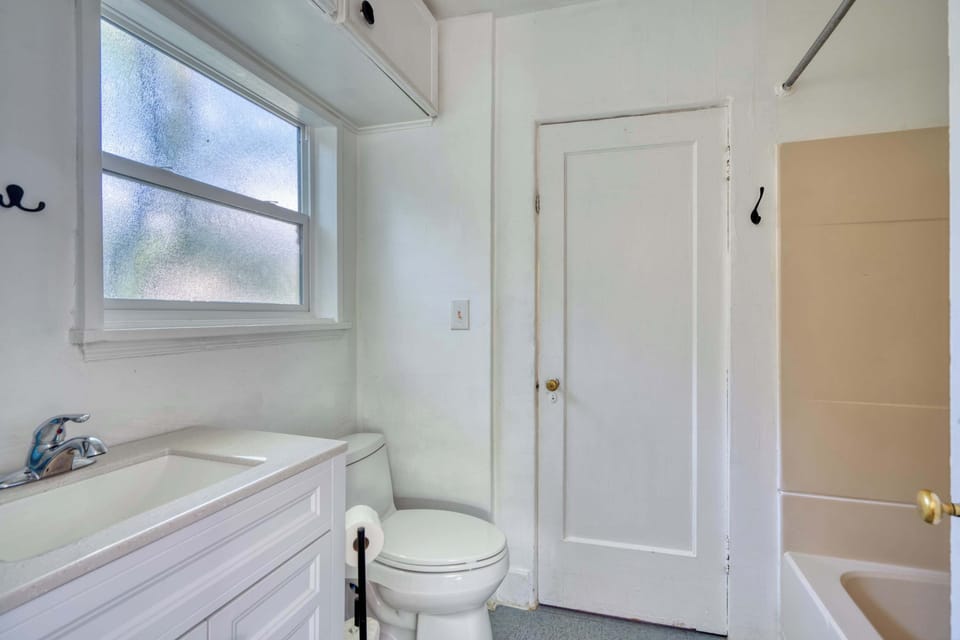 Bathroom with a tub/shower, sink vanity and toilet.