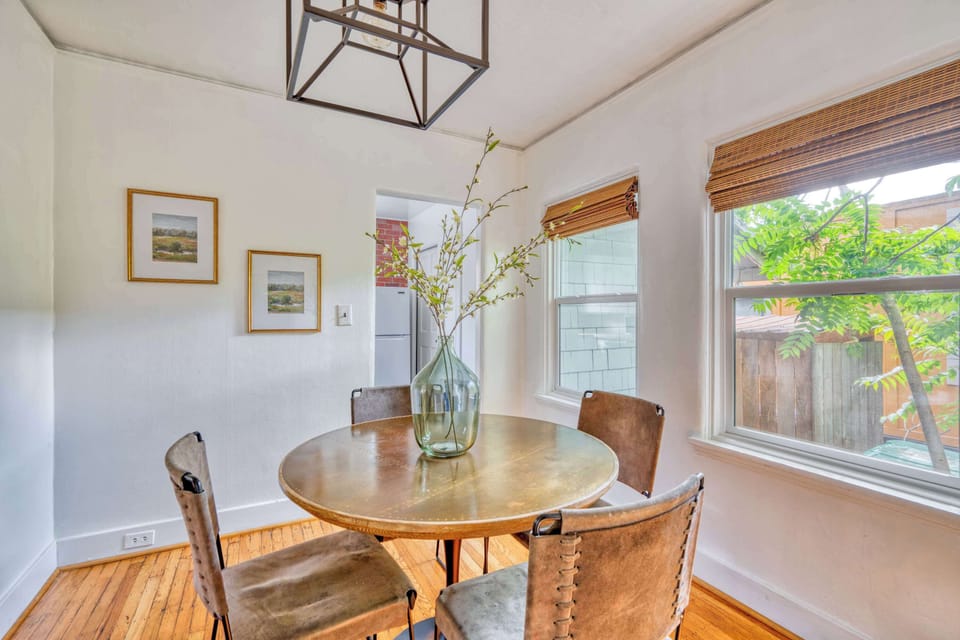 Dining room with round table and windows.