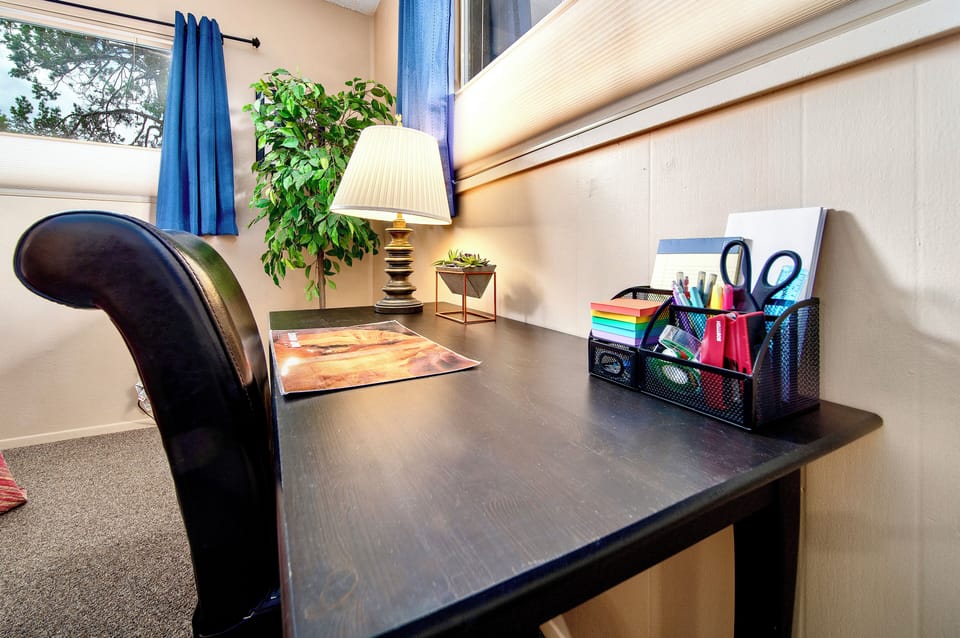 The King Room's desk, chair & lamp serve as a workspace, stocked with supplies.