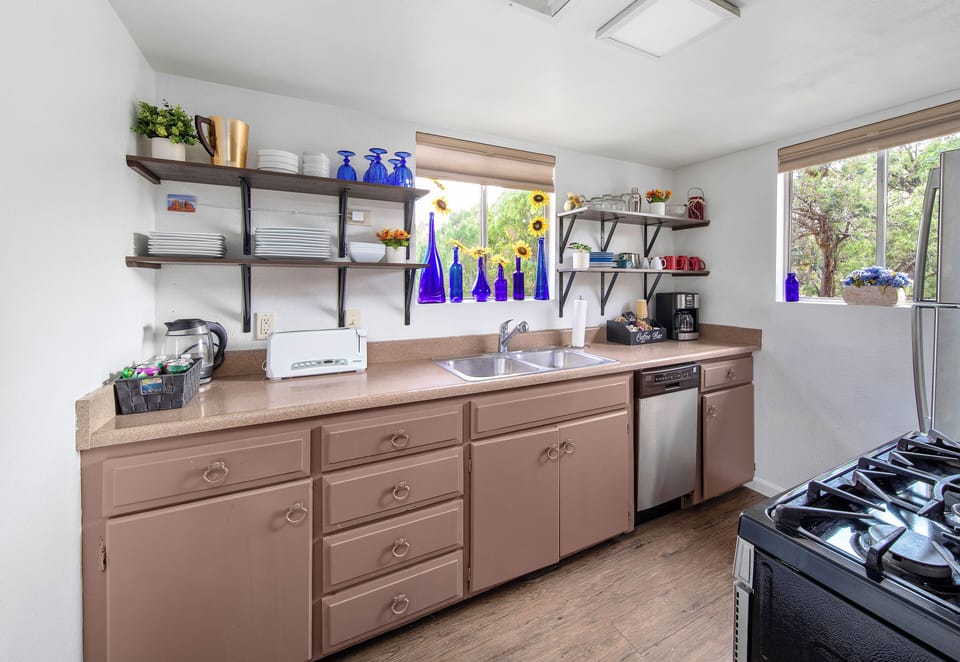 Our kitchen is complete with full glassware, dinnerware, and a dishwasher.