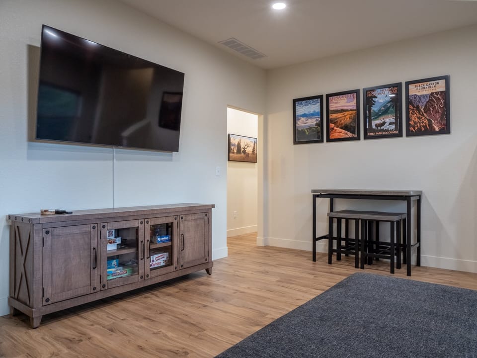 Downstairs Living Room with Large Sectional and Smart Tv in Walk-Out Basement
