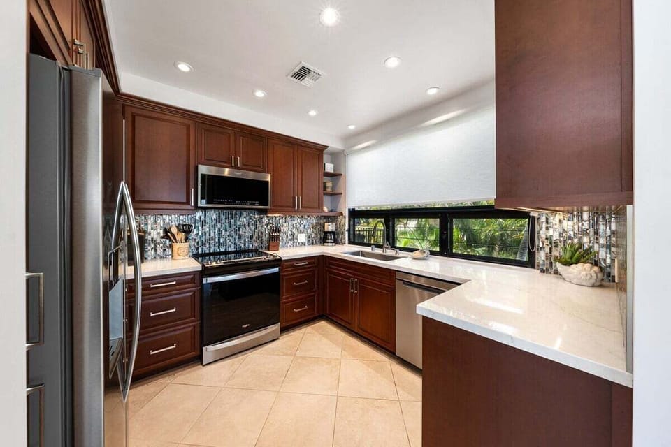 Modern open-layout kitchen with stainless steel appliances, granite countertops, and generous prep space for effortless home cooking.