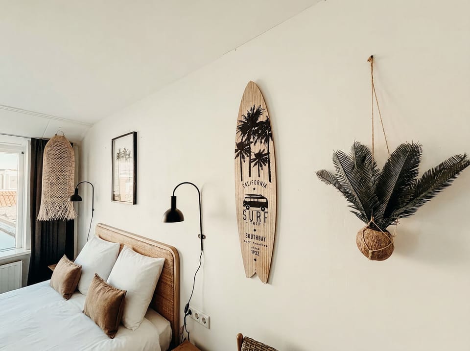 Cozy bedroom with a comfortable double bed, warm lighting, natural textures, and a calm, inviting atmosphere.