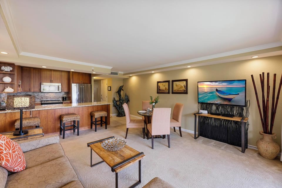 This beautifully designed open-concept living space features a fully equipped kitchen, elegant dining area, and cozy lounge with a smart TV—perfect for a relaxing Maui getaway.