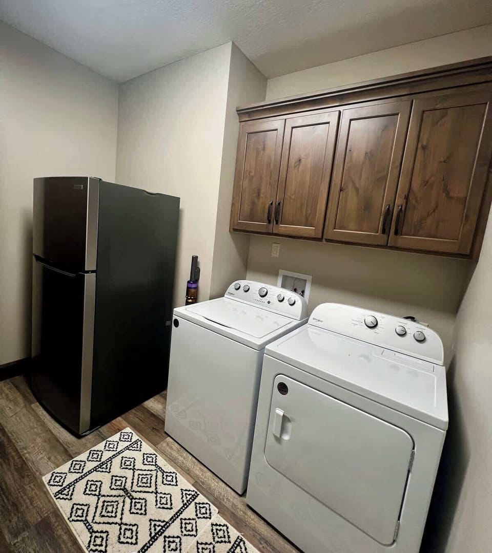 Additional refrigerator in laundry room. 
