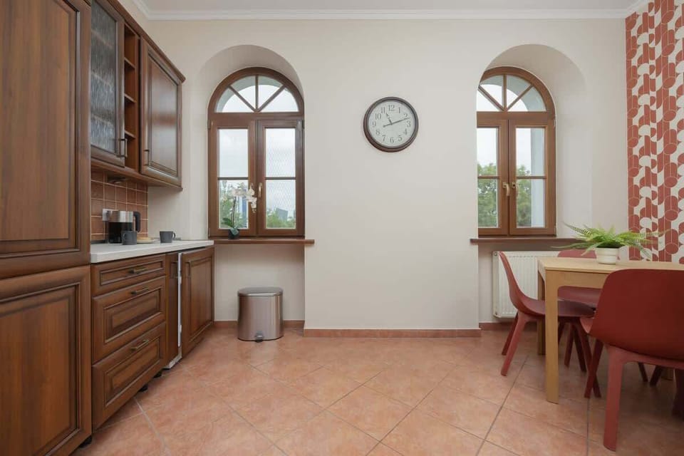 A classic kitchen with distinctive arched windows combines functionality with unique style.
