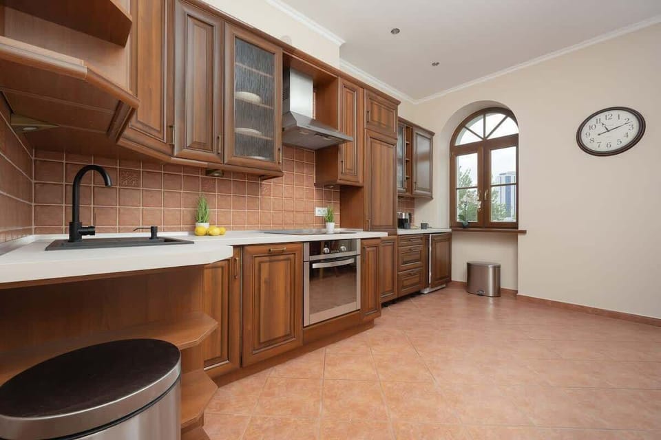 A bright kitchen with wooden cabinets and a spacious worktop is perfect for comfortable cooking.