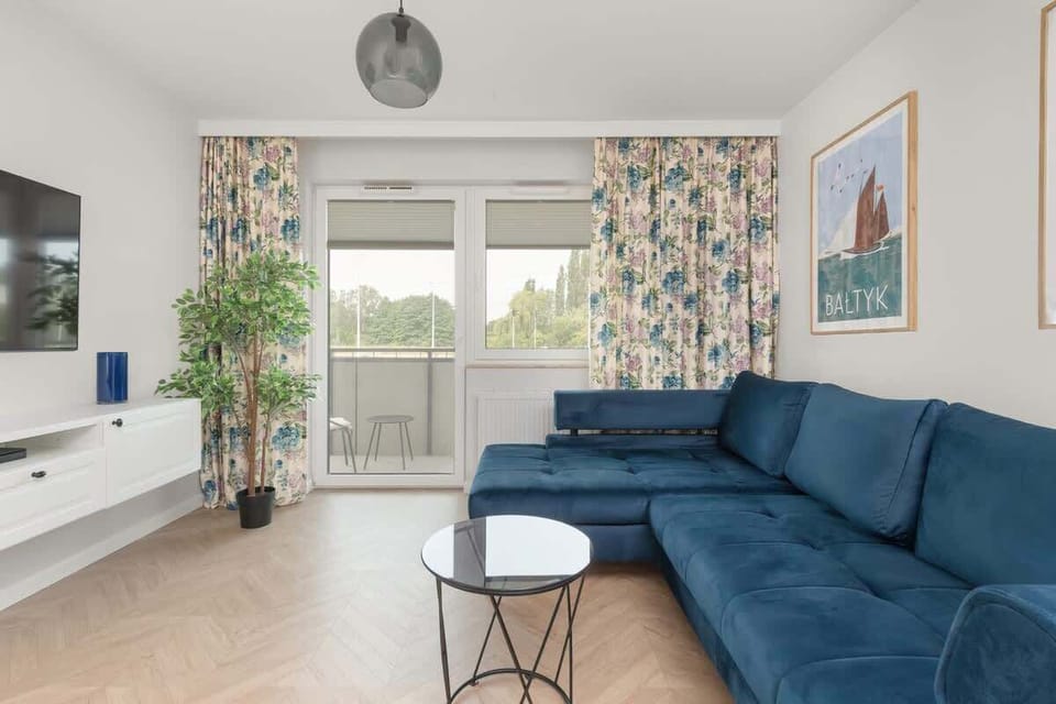 The elegant living room featuring a double sofa bed, perfect for relaxing or sleeping.