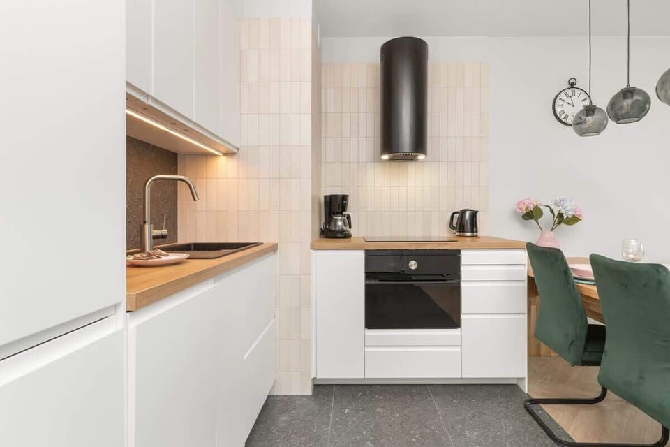 The sleek design of the kitchenette blending seamlessly with the living area.