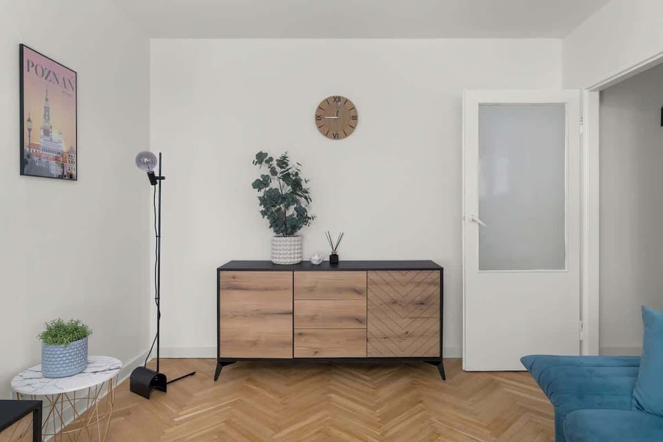 Living room with double sofa bed and television.