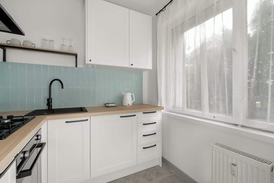 Kitchenette with a kettle and an oven.