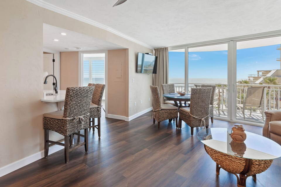 View from living room to kitchen breakfast bar and dining table.