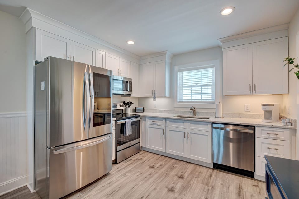 Your modern kitchen awaits with stainless steel appliances, granite counters, and crisp white cabinetry for effortless meal prep.
