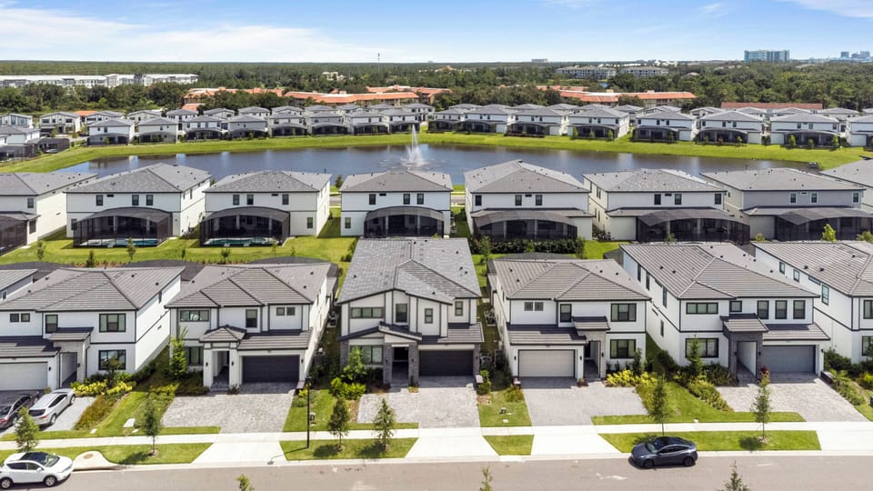 Explore a lively neighborhood by a beautiful lake, where modern homes feature stylish architecture and well-kept lawns. Experience serene views and a welcoming atmosphere, highlighted by plenty of natural light and lush greenery.