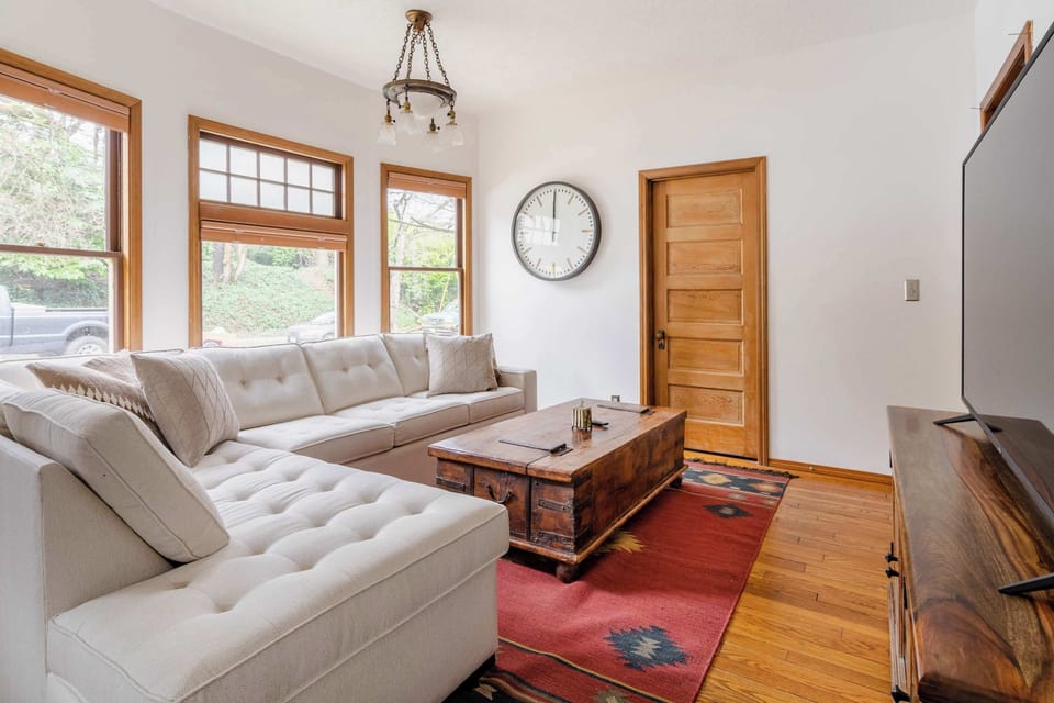Living room seating with bright windows.