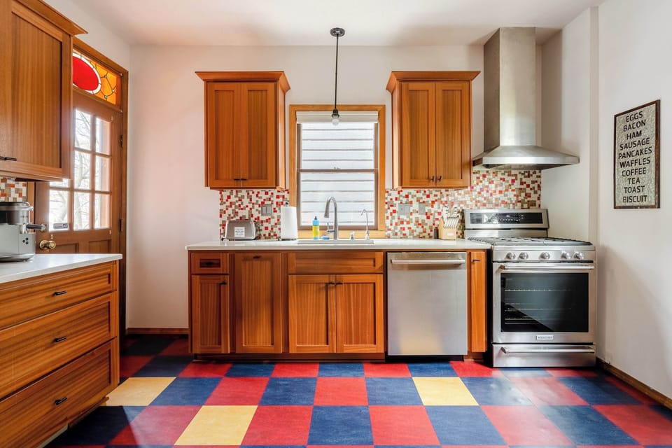 Kitchen with colorful floors and gas range.