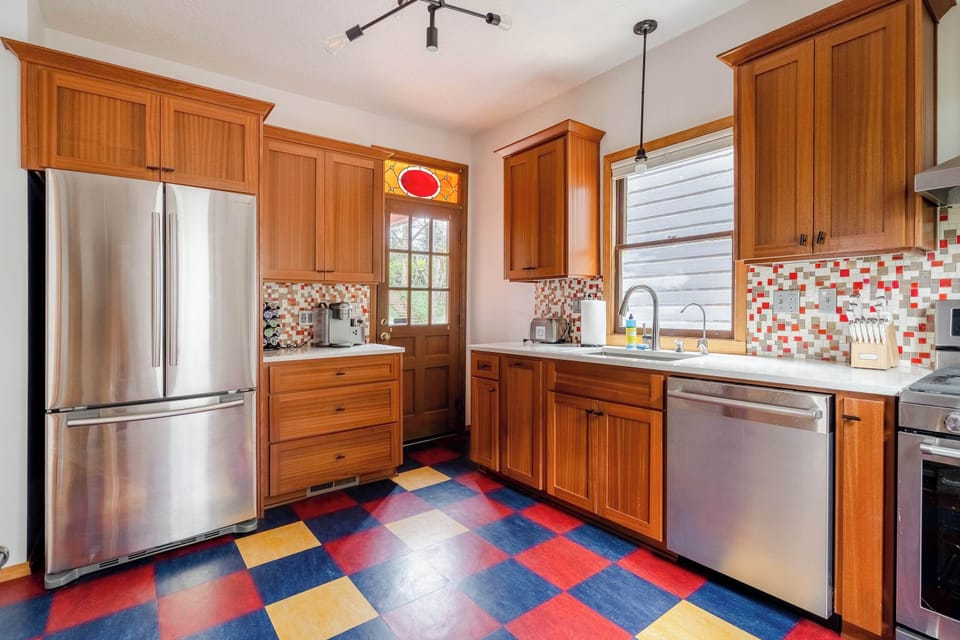 Kitchen with stainless refrigerator.