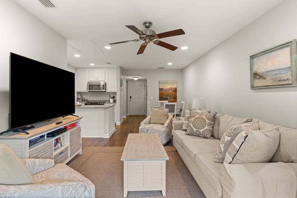 Cook, eat, play, and watch in the open concept living area.