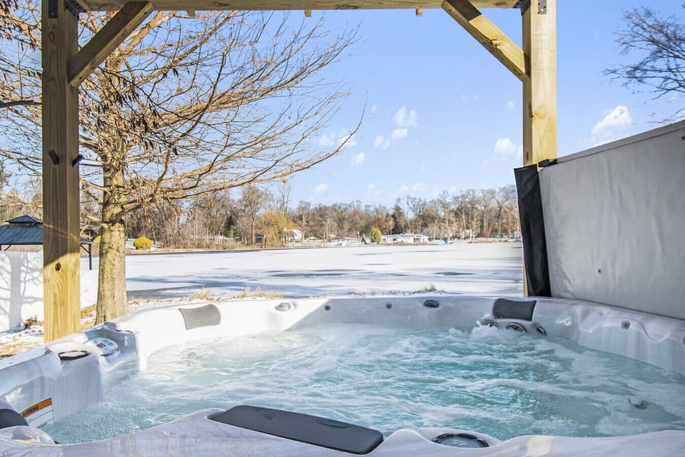 Soak in the hot tub while surrounded by serene winter beauty—perfect for relaxation after a day of fun.