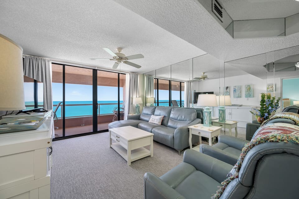 Spacious living room with direct Gulf views, flat-screen TV and Queen Memory Foam Cabinet Bed.