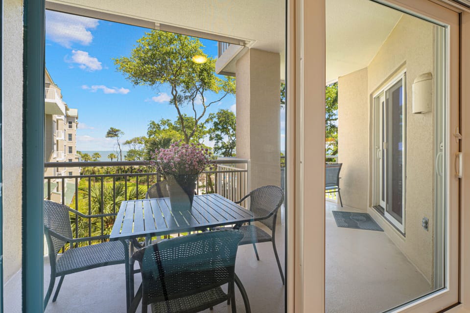 The private balcony extends your living space outdoors and offers a peaceful setting to enjoy ocean breezes and partial views of the Atlantic through the treetops.
