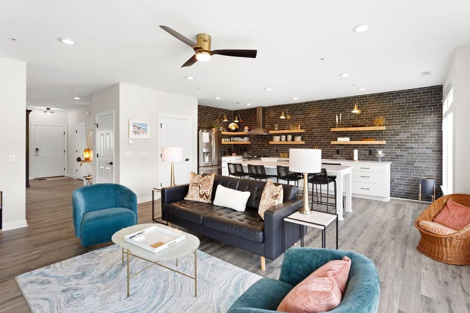 Relax in this spacious Living Area with a large Flat Screen TV and lots of brilliant, natural light.