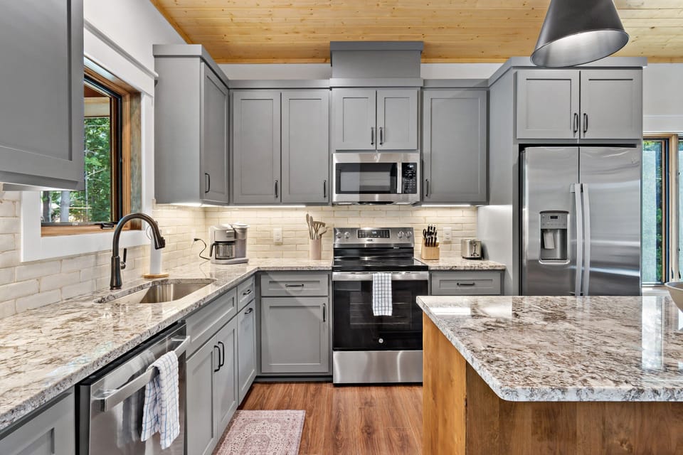 Well-equipped kitchen with island seating for 3, dishwasher, and combination drip-style and Keurig coffee maker