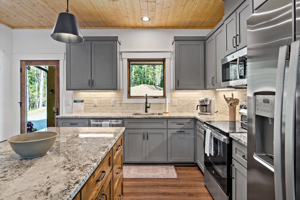 Well-equipped kitchen with island seating for 3, dishwasher, and combination drip-style and Keurig coffee maker
