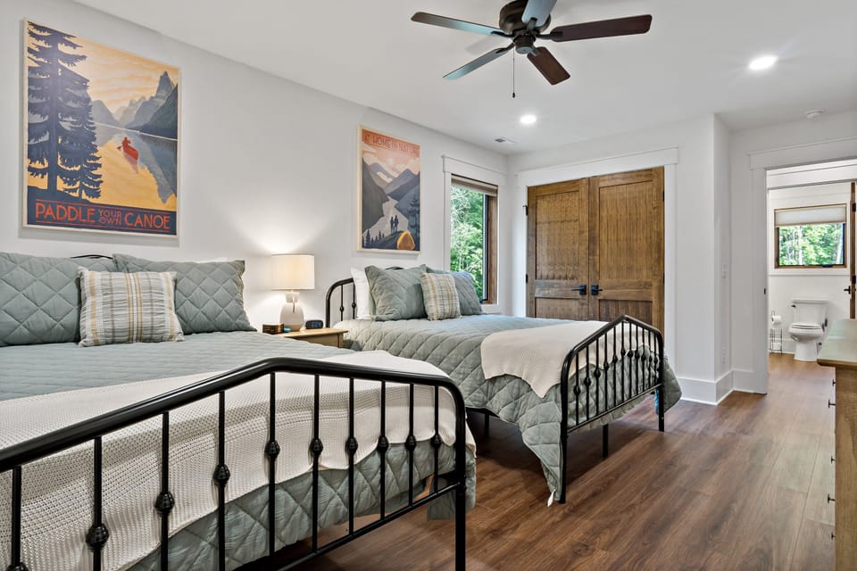 Upper-level bedroom with two queen-size beds and 45" Roku TV