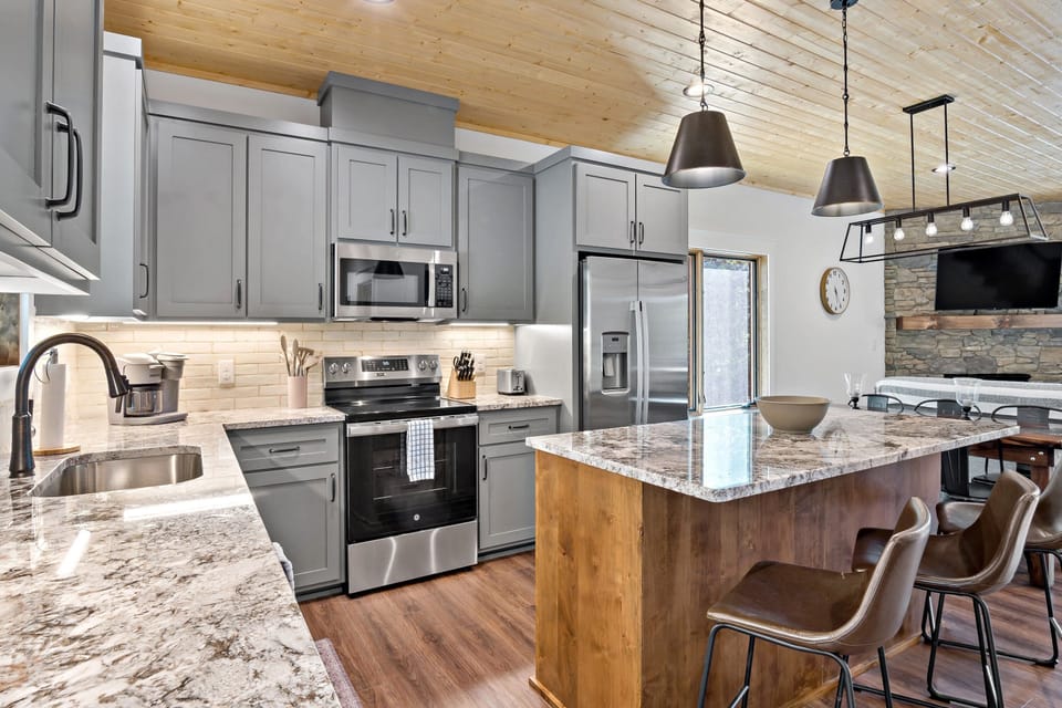Well-equipped kitchen with island seating for 3, dishwasher, and combination drip-style and Keurig coffee maker