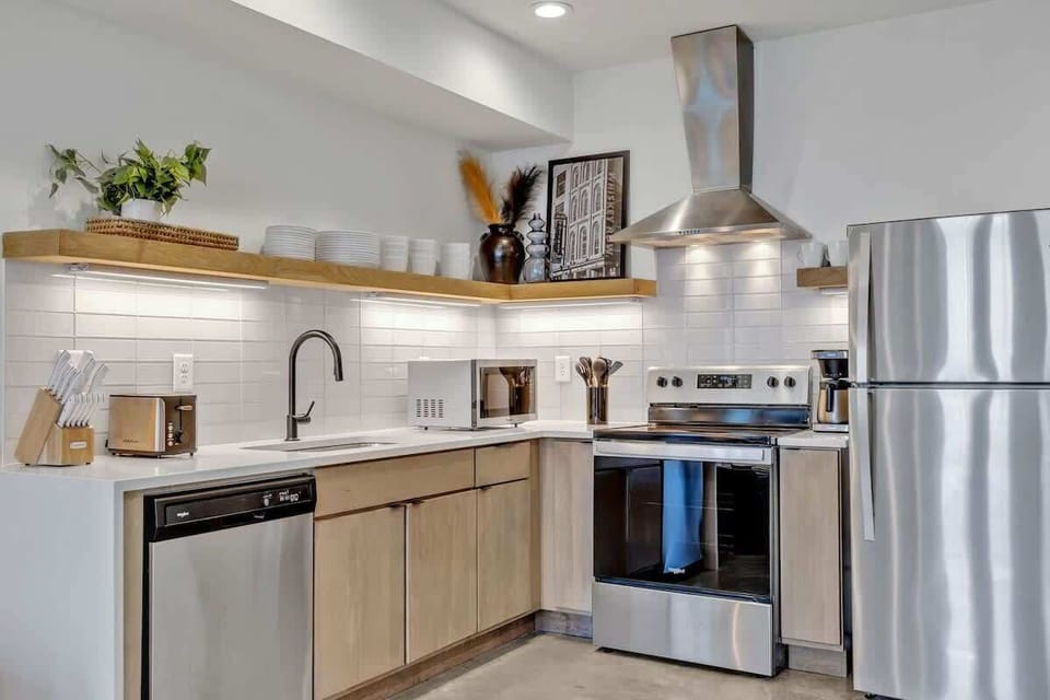 Lower Unit: Fully equipped kitchen stocked with all culinary essentials and boasting stainless-steel appliances.