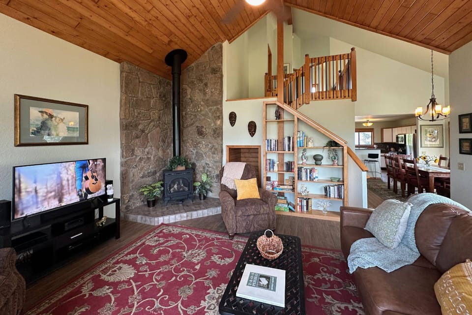 Wood burning fireplace, books galore and a smart tv in this comfy family room